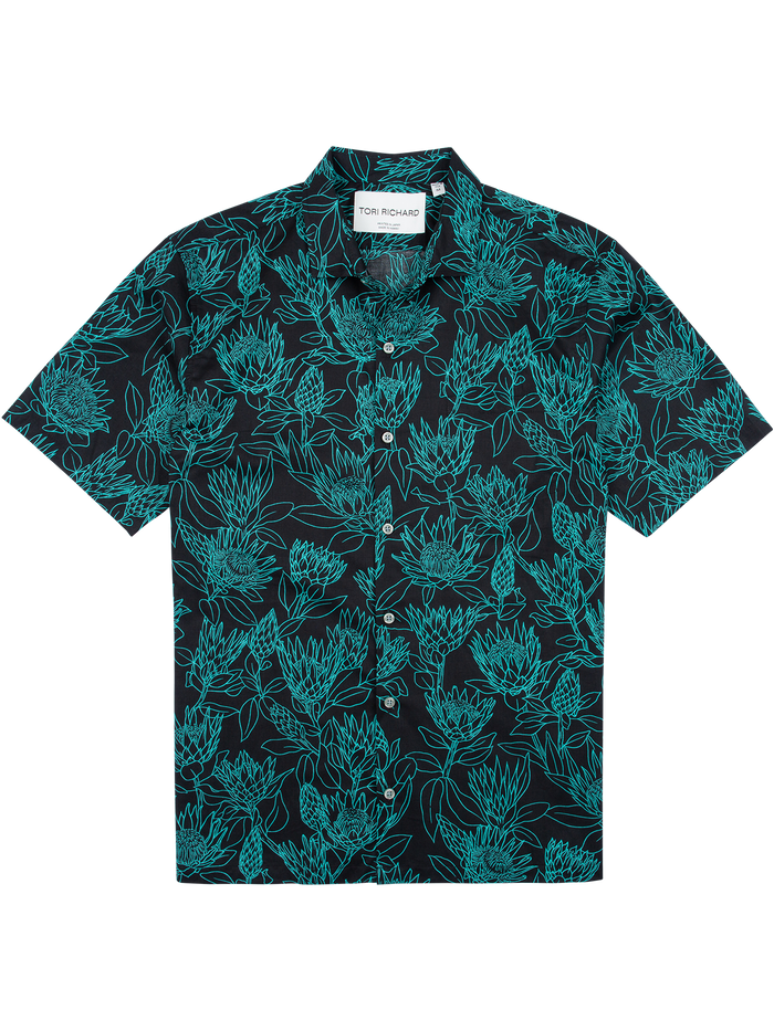 Black short-sleeve shirt with teal floral print, button front, and visible white collar tag.