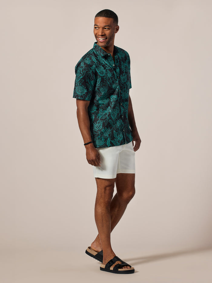 Green Protea-print short-sleeve shirt with white shorts, front view