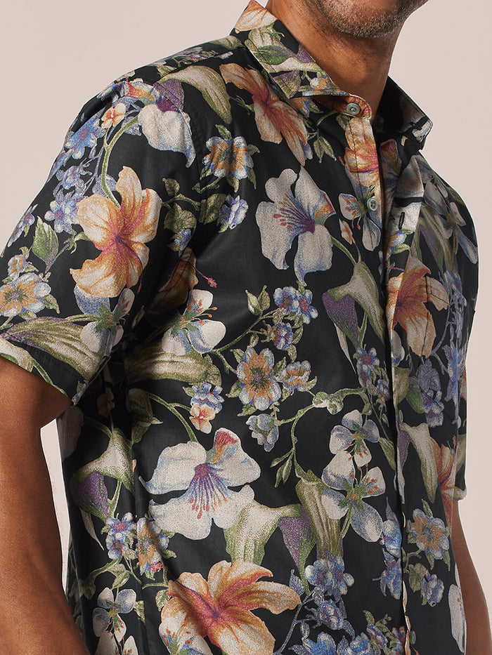 Black shirt with colorful floral pattern, short sleeves, button-up front view.