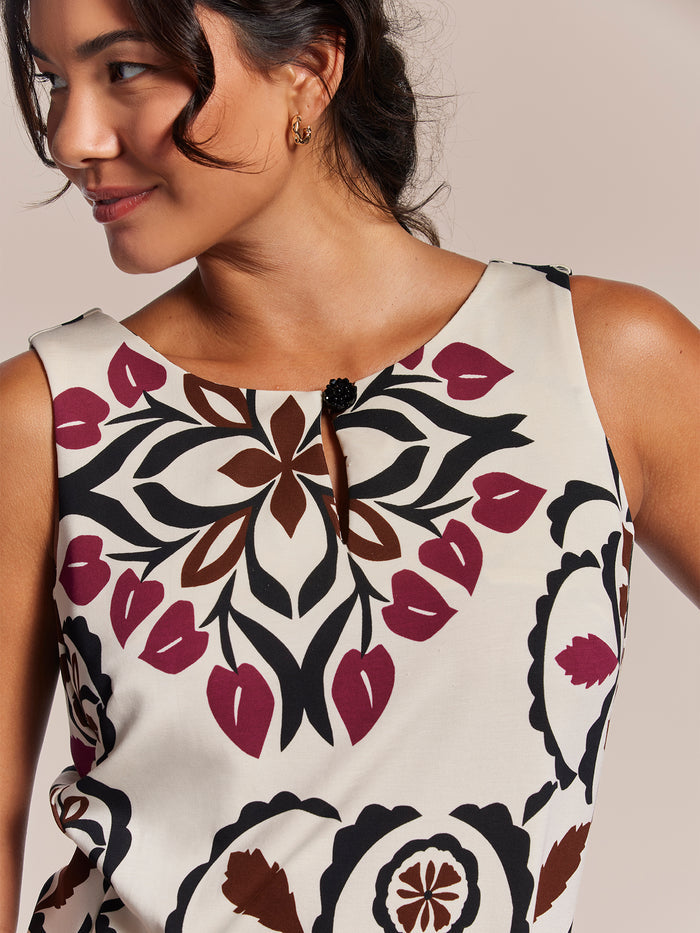 Maroon, black, and brown floral quilted dress inspired by Hawaiian quilts, front view.
