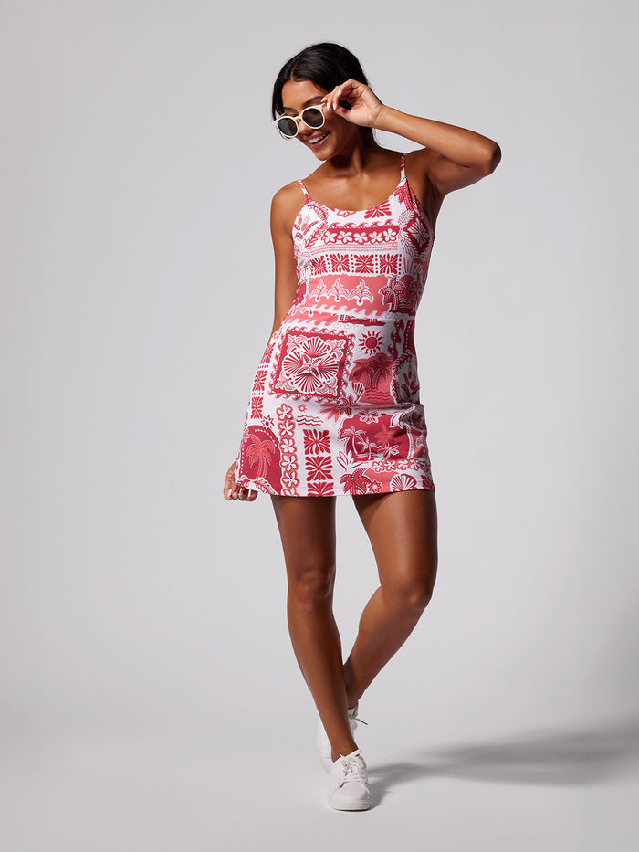 Red and white solid romper, front view with sneakers and sunglasses on gray background.