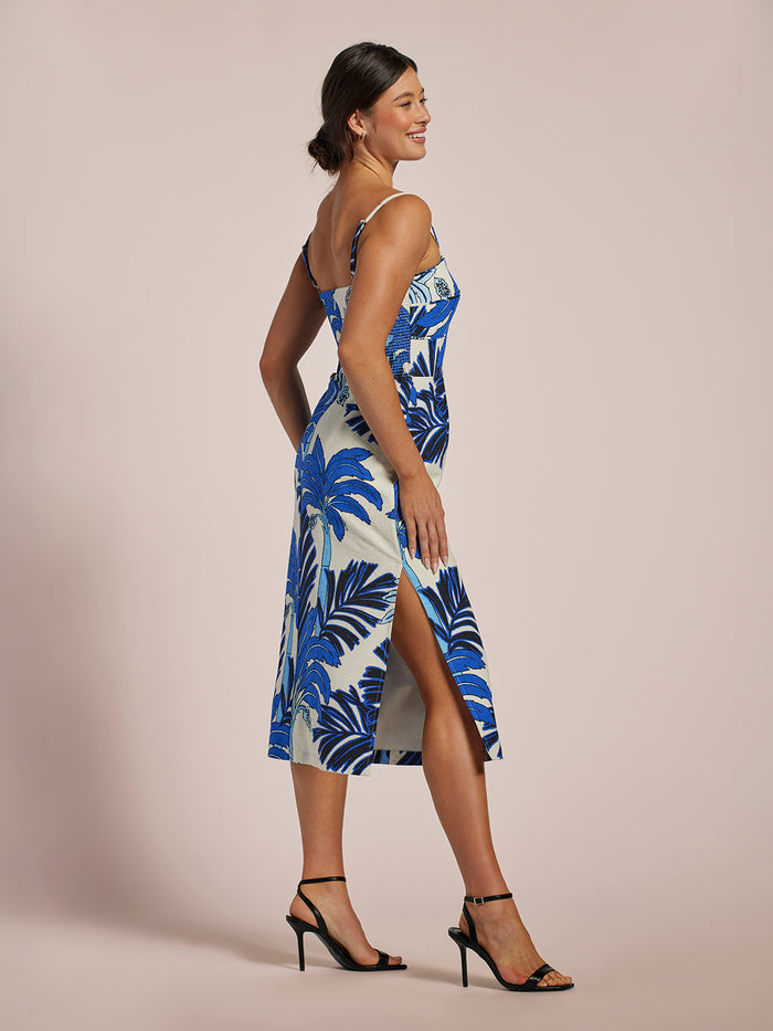 Blue and white floral-print sleeveless midi dress with side slit, front view.