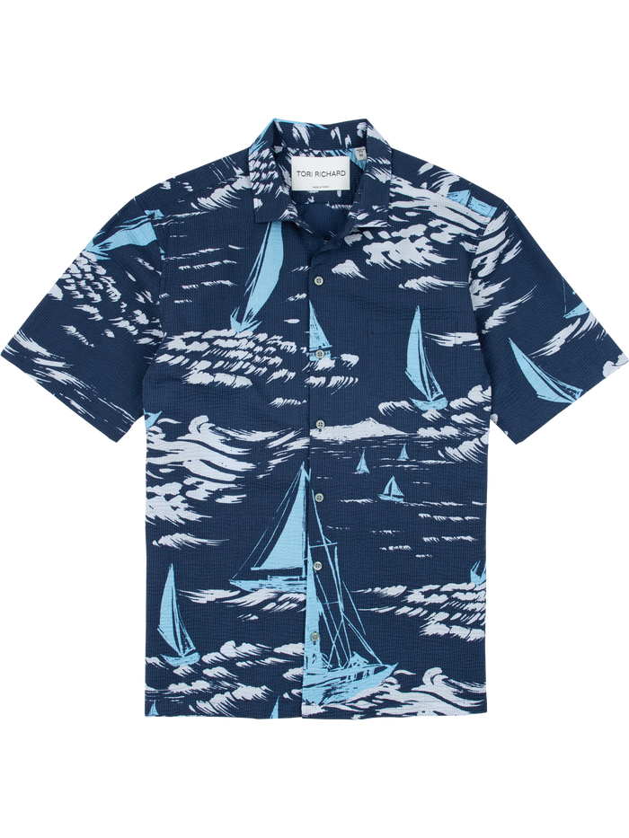 Navy blue sailboat-print short-sleeve shirt, Hawaiian-inspired, front view.