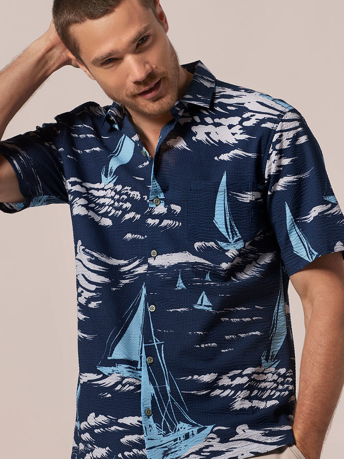 Navy blue sailboat-print short-sleeve shirt, front view  of a model.