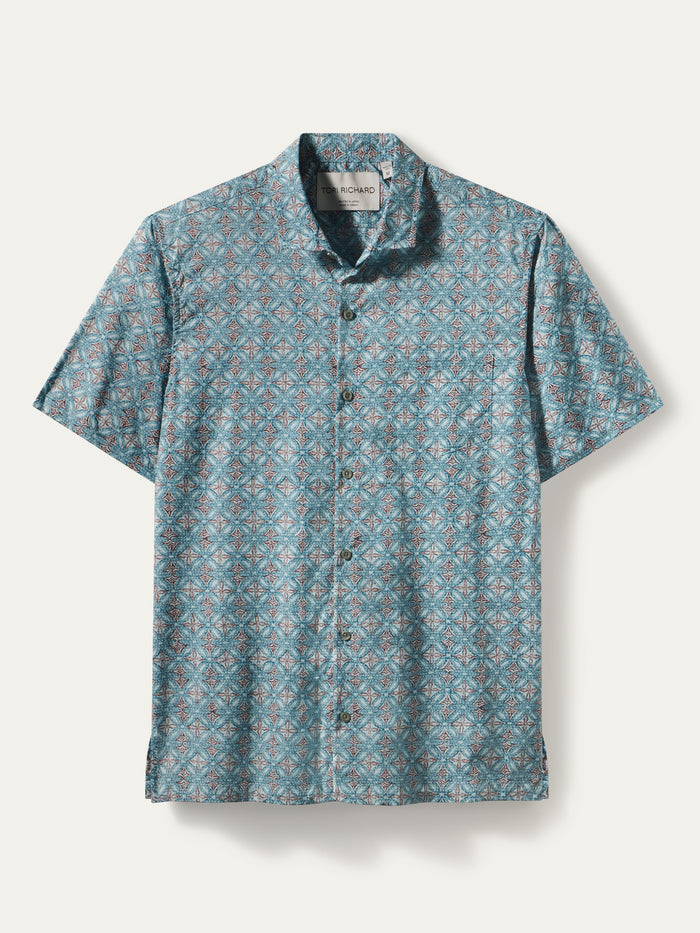 Blue and pink geometric-print short-sleeve cotton shirt shown laid flat front view.