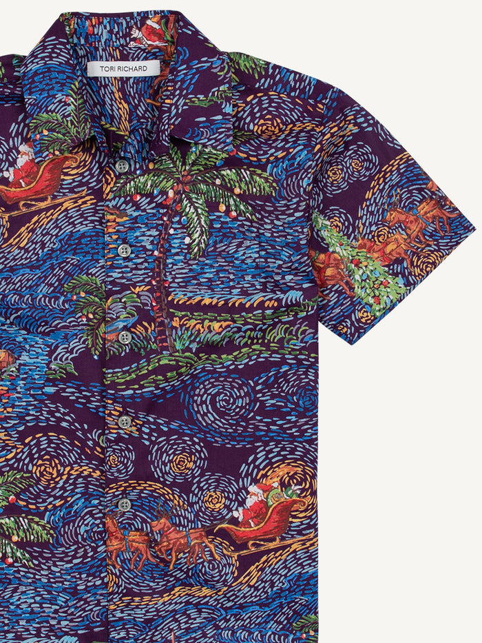 Blue, green, and orange tropical horse-print cotton shirt with pocket and white buttons, front view.
