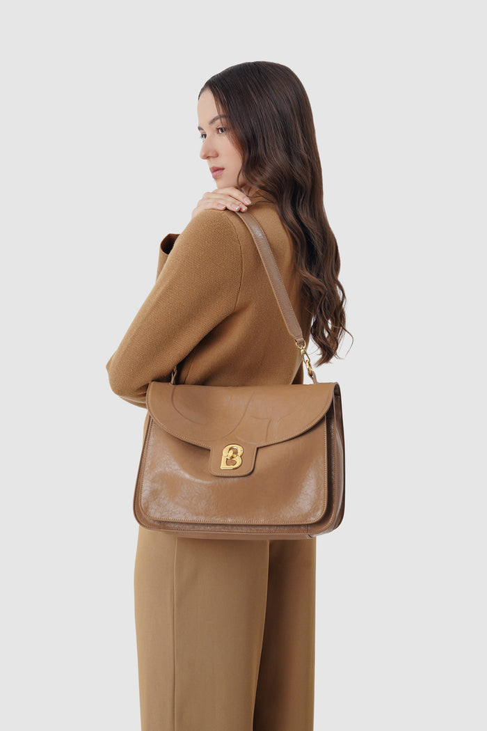 savina bag in brown by buttonscarves carried on shoulder