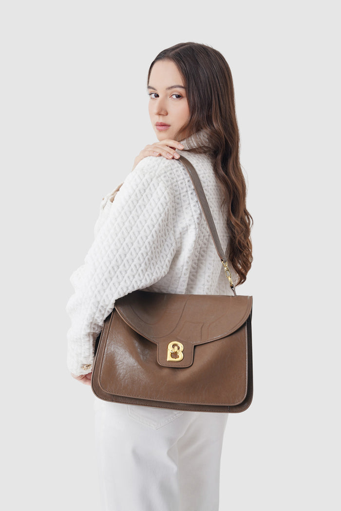 savina bag in chocolate by buttonscarves carried on shoulder