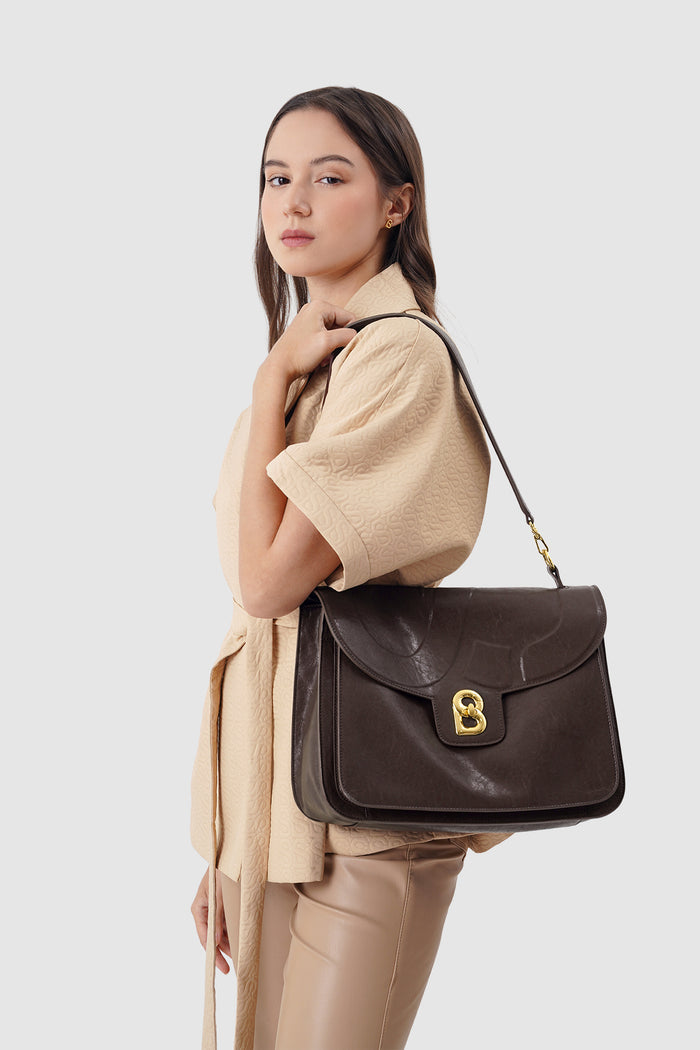 savina bag in dark brown by buttonscarves carried on shoulder