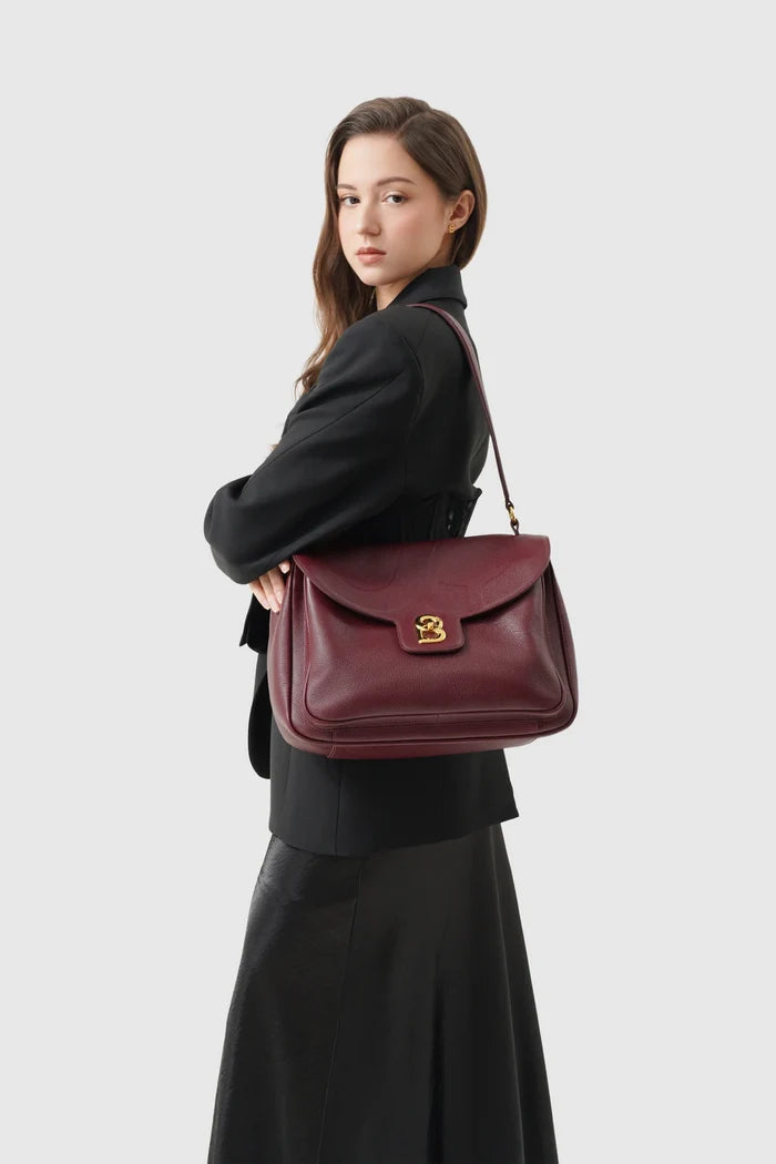 savina bag pebble leather in dark cherry by buttonscarves carried on shoulder