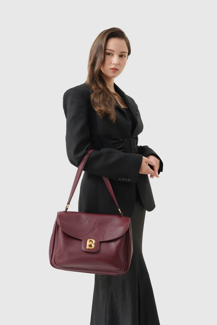 savina bag pebble leather in dark cherry by buttonscarves carried on wrist