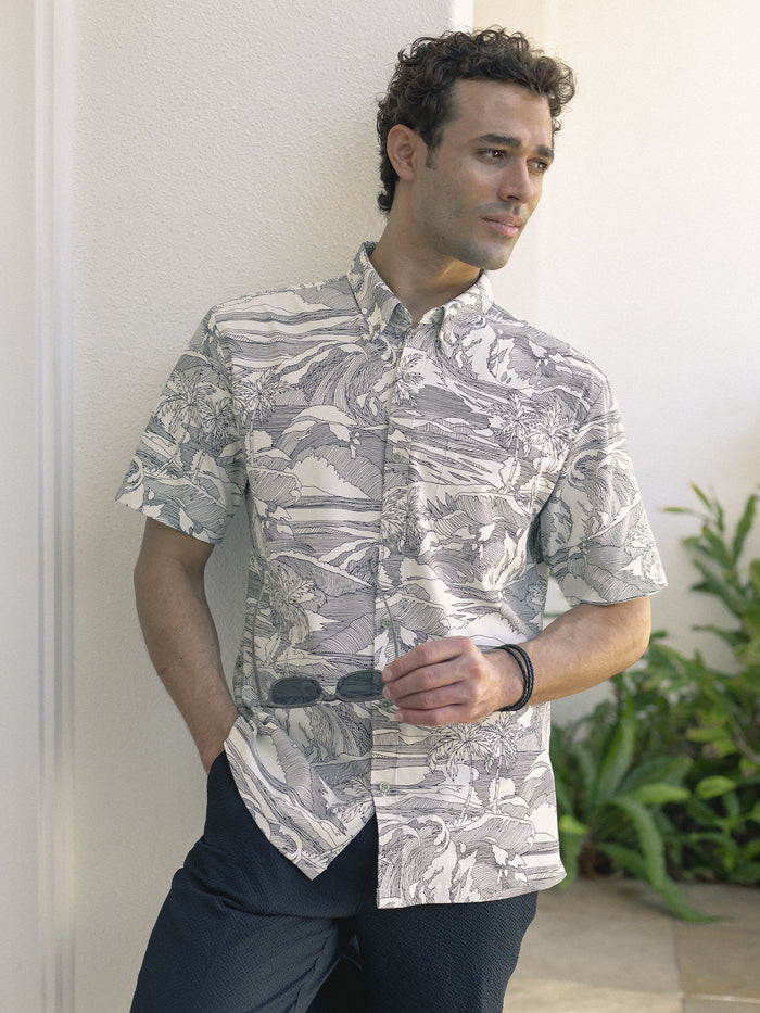 Gray and white nature-print short-sleeve shirt with UPF, front view, with dark pants.