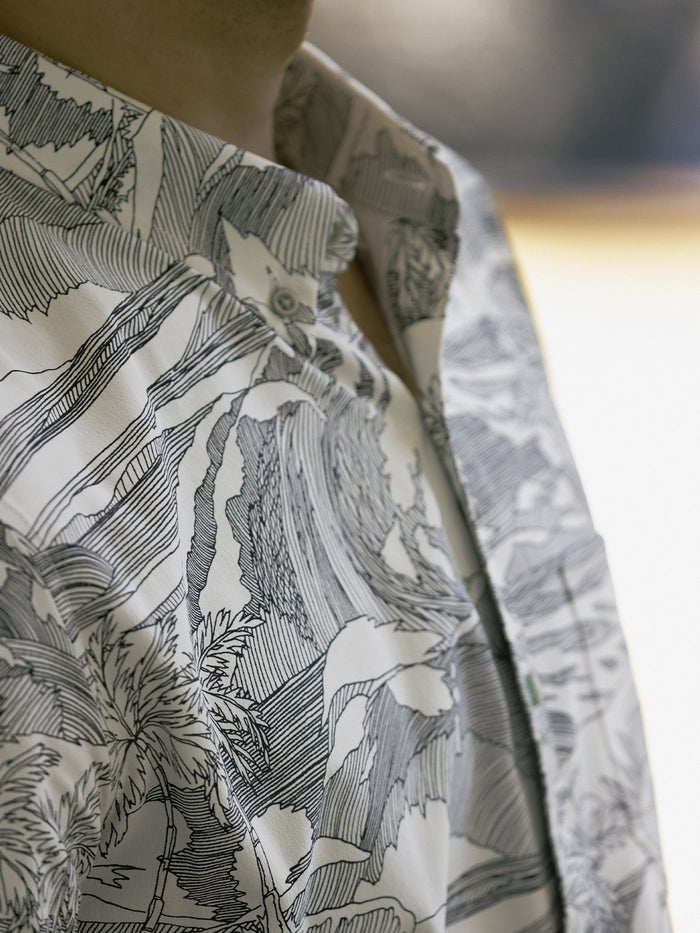 Gray and white nature-print short-sleeve shirt with UPF, close-up of quick-dry fabric.