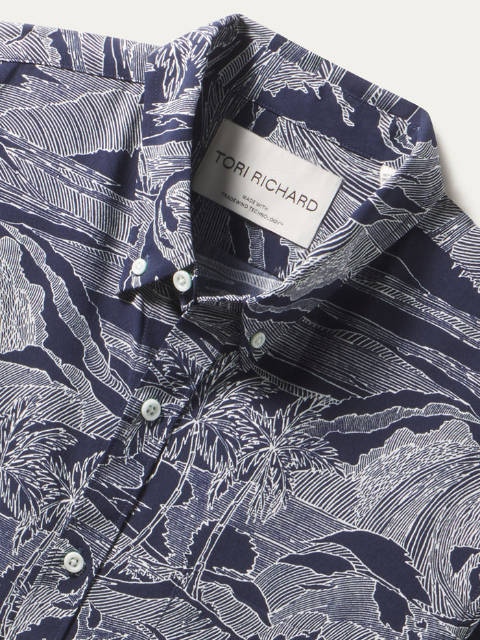 Navy button-up long sleeve shirt with white tropical line print, shown from the front.