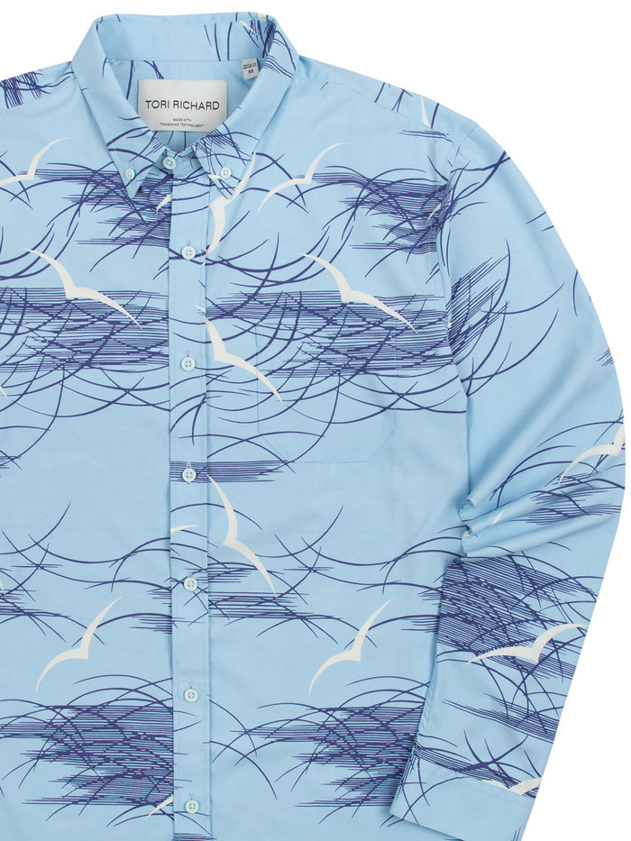 Light blue long-sleeve shirt with white seagull and navy wave print, shown front and angled view.