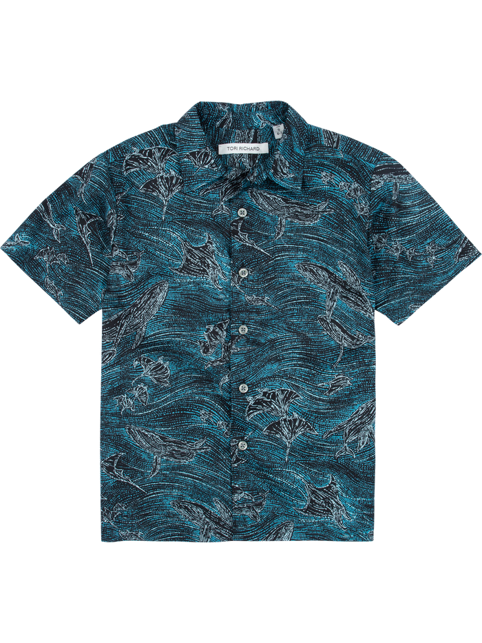 Blue shirt with white whale and manta ray print, short sleeves or button-down cotton, front view.