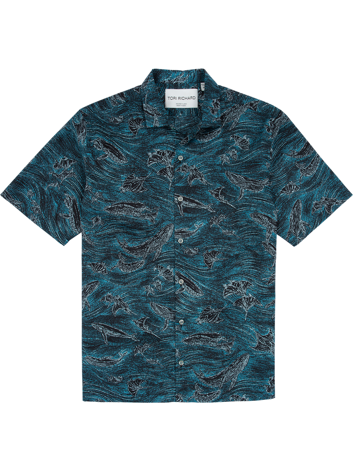 Blue short-sleeve shirt with black and white ocean wave and fish print pattern, front view.