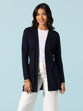 Navy knit duster, open front, over white shirt and pants, front view.
