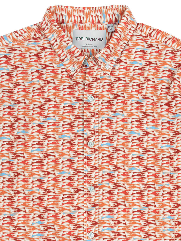Red and orange fish patterned long-sleeve shirt, close-up of collar and label .