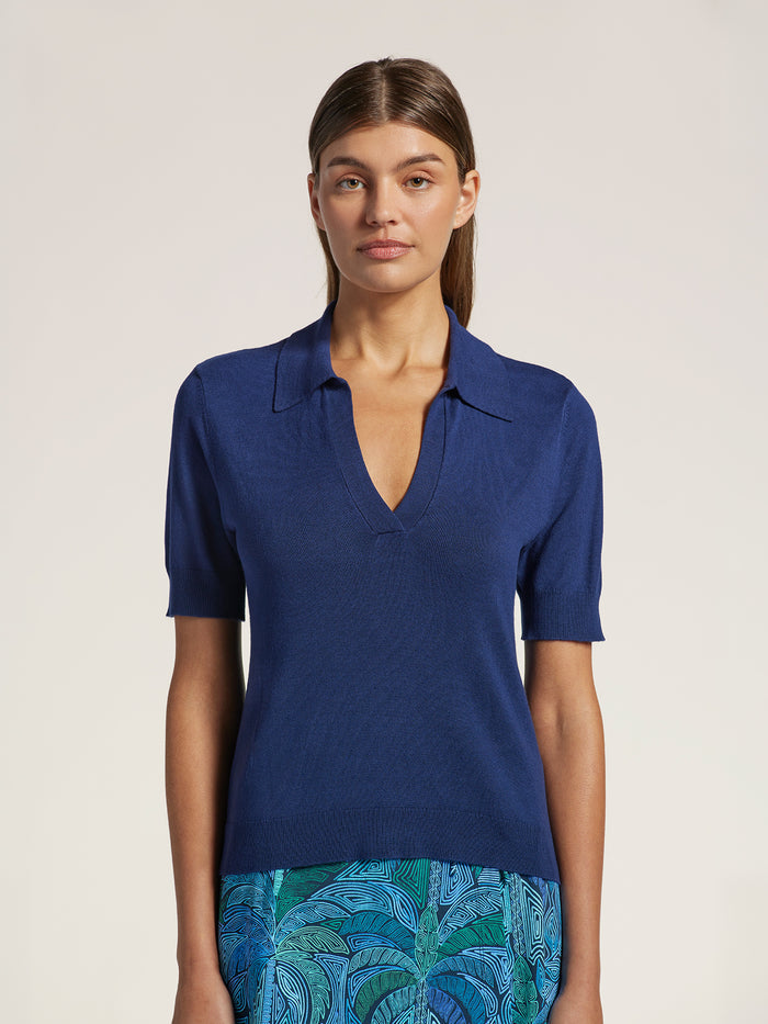 Navy blue ribbed-knit Trinny sweater and teal skirt, full front view.