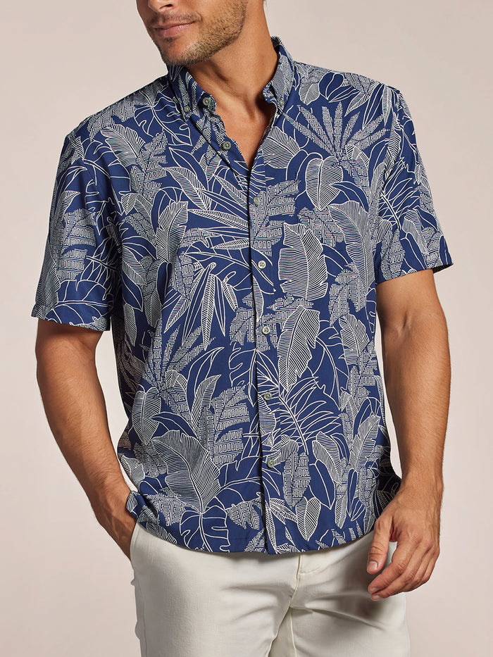 Navy quick-dry short-sleeve shirt with white leaf print and white pants, front view.