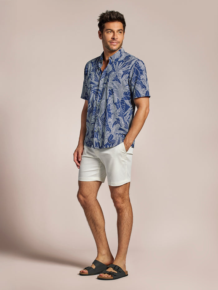 Navy short-sleeve shirt, white shorts, black sandals, straight-on view in both images.