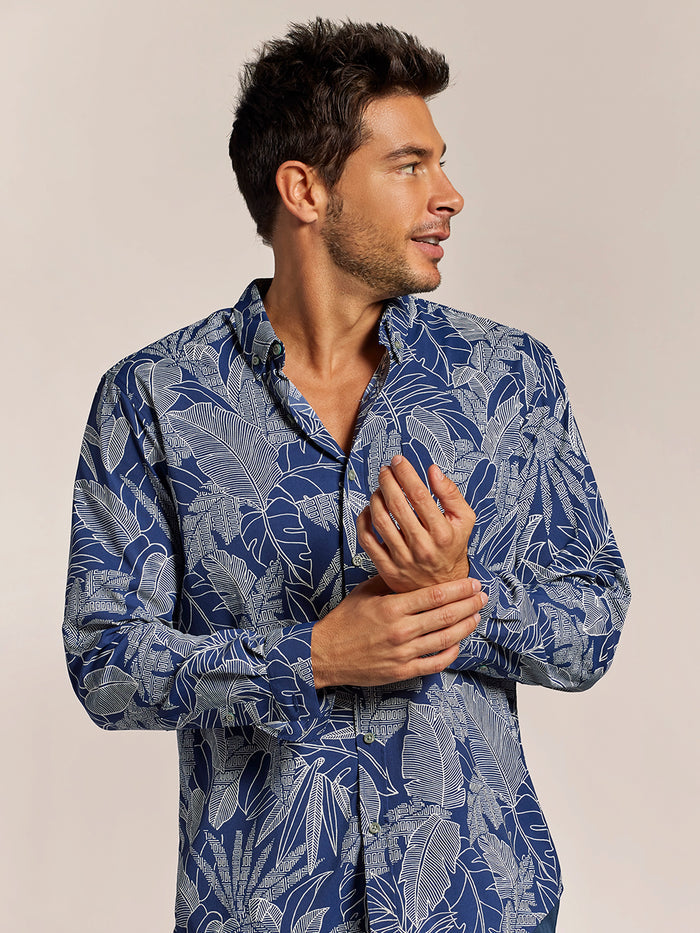 Navy leaf-print long-sleeve shirt, left side view with hands together.