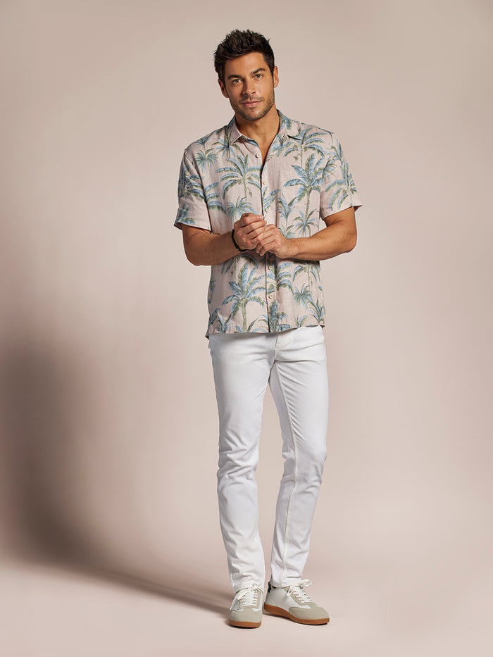Beige palm tree print linen shirt with white pants, front and full body views against beige background.