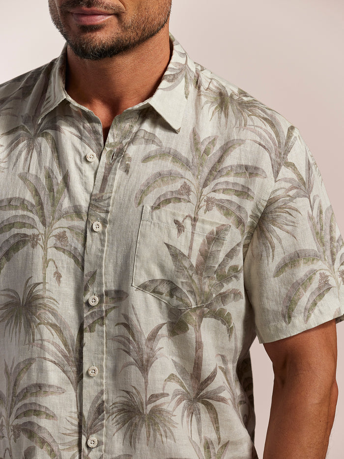White palm tree print linen shirt, shoulders to waist view.