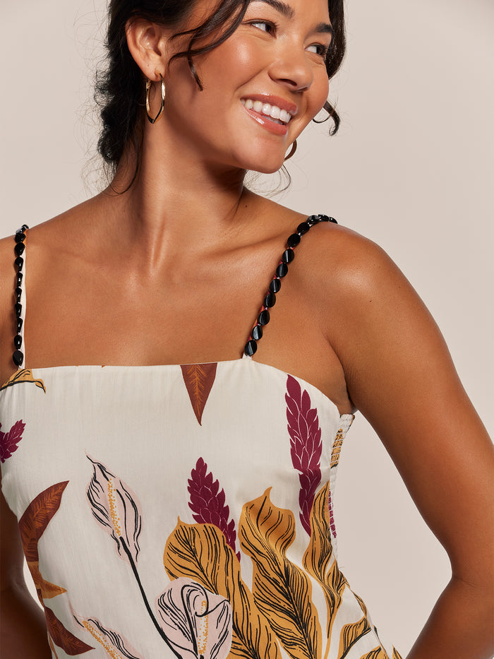 Ivory beaded-strap sleeveless dress, side view, shown against a plain neutral background.