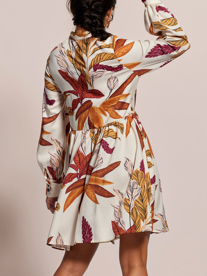 Brown and orange autumn-leaf print midi dress, back view.