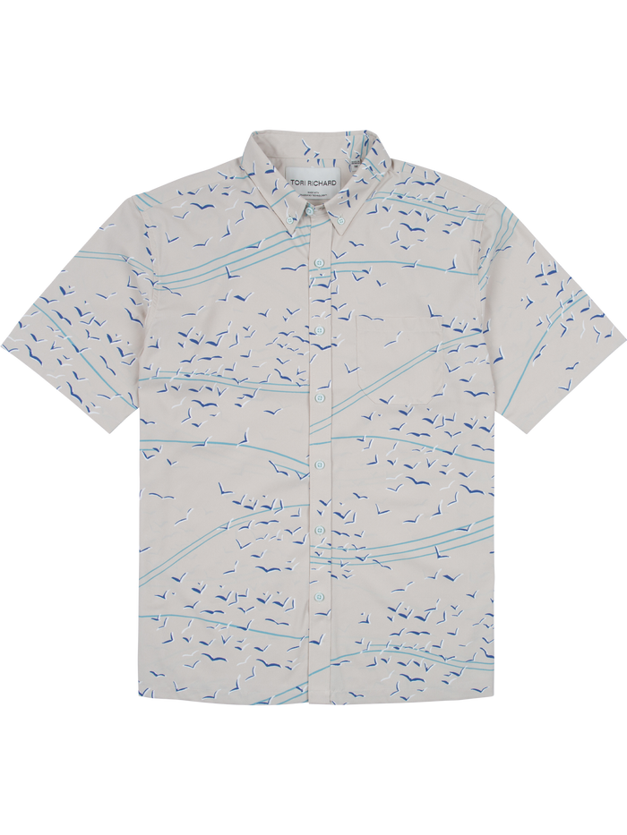 Light gray short-sleeve button-up shirt with blue bird print, front view.