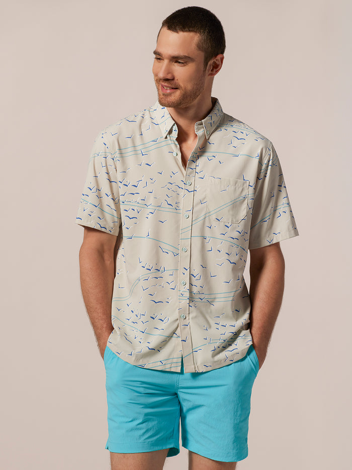 Light blue short-sleeve shirt with Sora–Tradewind Technology® logo, blue shorts, front view .