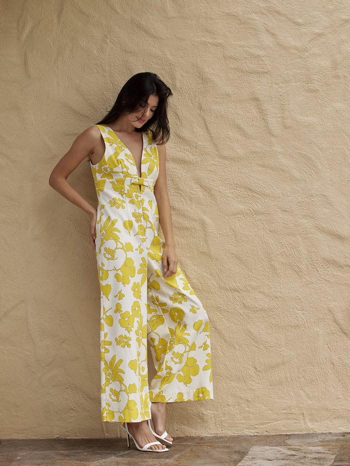 Sunny Dubonnet solid jumpsuit and heels, side view with hand on hip.