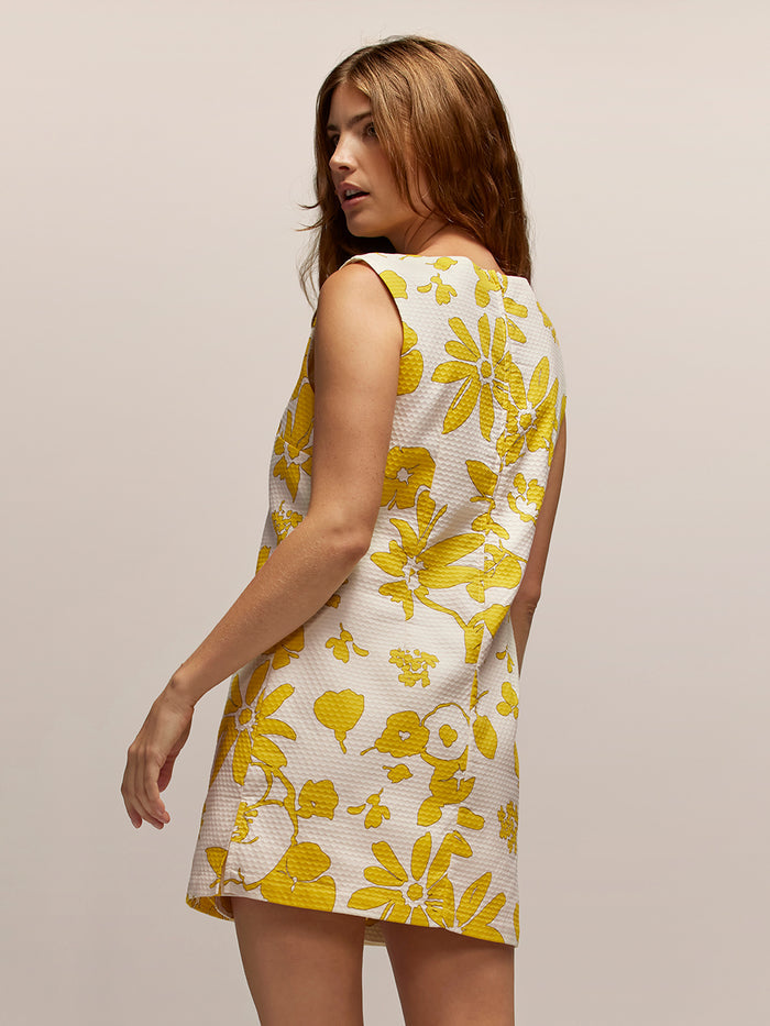 Yellow floral print romper, back view showing pattern and shoulder details.