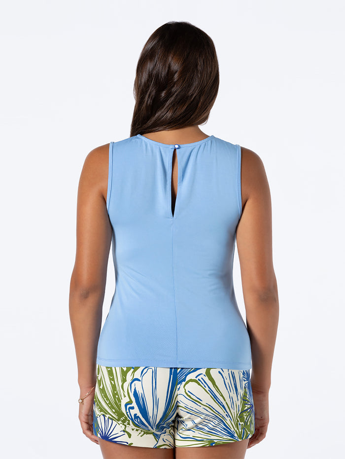 Light blue solid sleeveless top and patterned UPF 50 shorts, rear view.