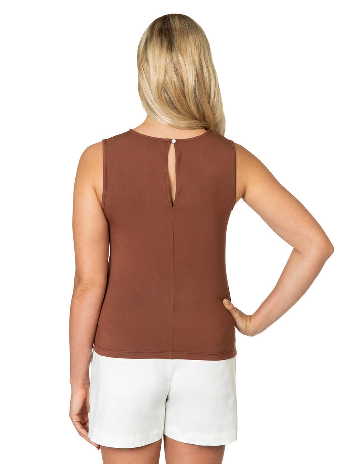 Plain brown Michelle top and white shorts, back view, hand on hip.