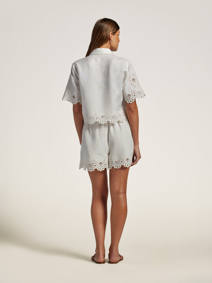 White linen top and shorts with eyelet trim, back view.