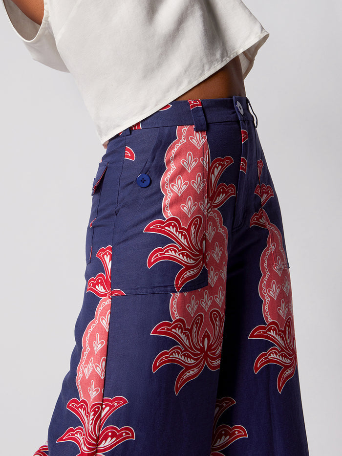 Navy linen-viscose pants with red/pink pineapple print, waist to mid-thigh, front view.