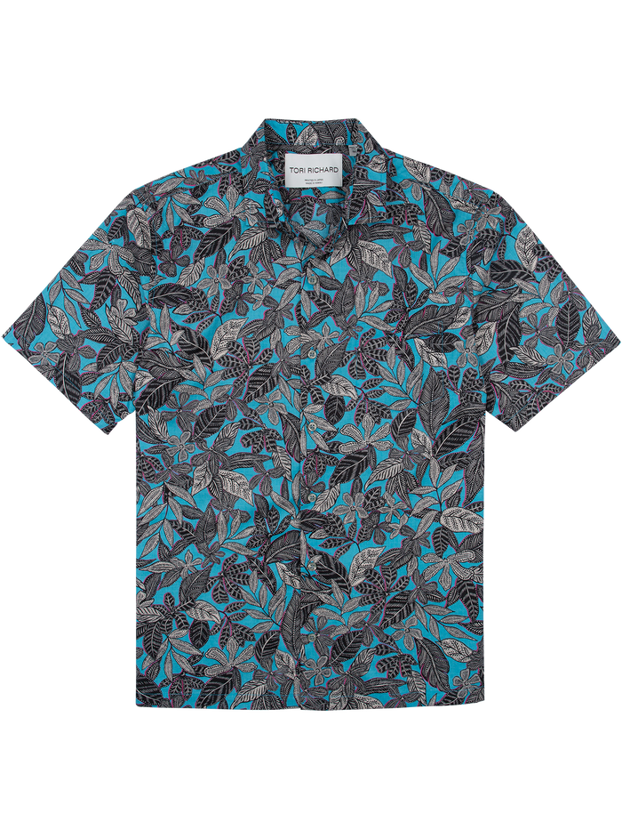 White shirt with blue, black, and gray tropical leaf print, lightweight cotton lawn, front view.