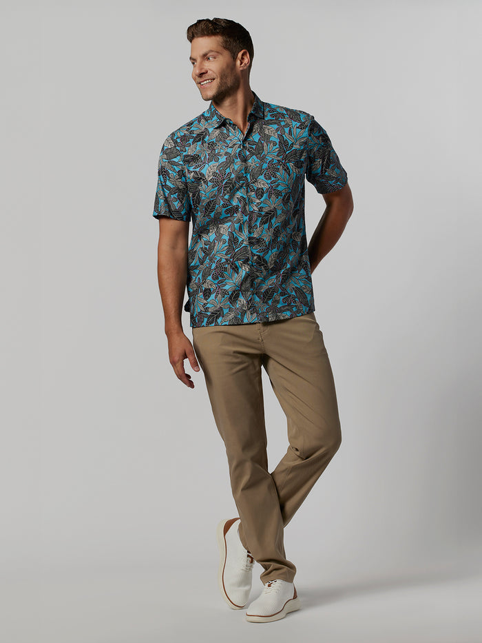 Man in blue short-sleeve shirt, tan pants, and white shoes, front view.