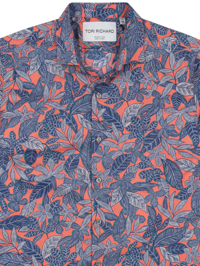 Vibrant pink shirt with blue and white tropical leaf print, front view shown in both images.