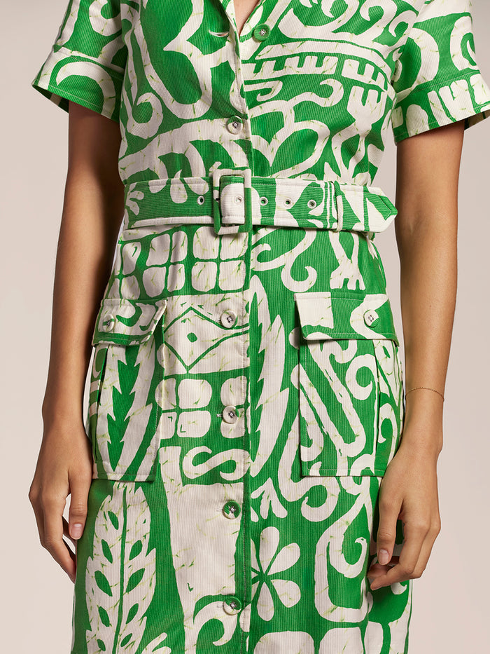Green/white patterned knee-length dress, button front, matching belt, pockets, front view.