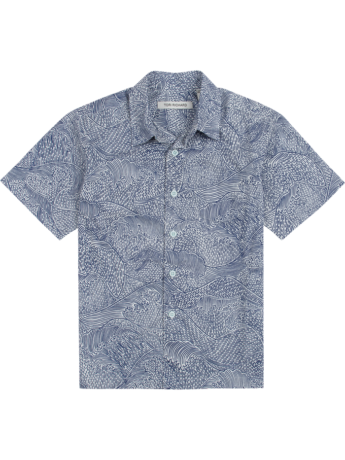 Blue shirt with white ocean wave print, short sleeves, button-up front view shown in both images.