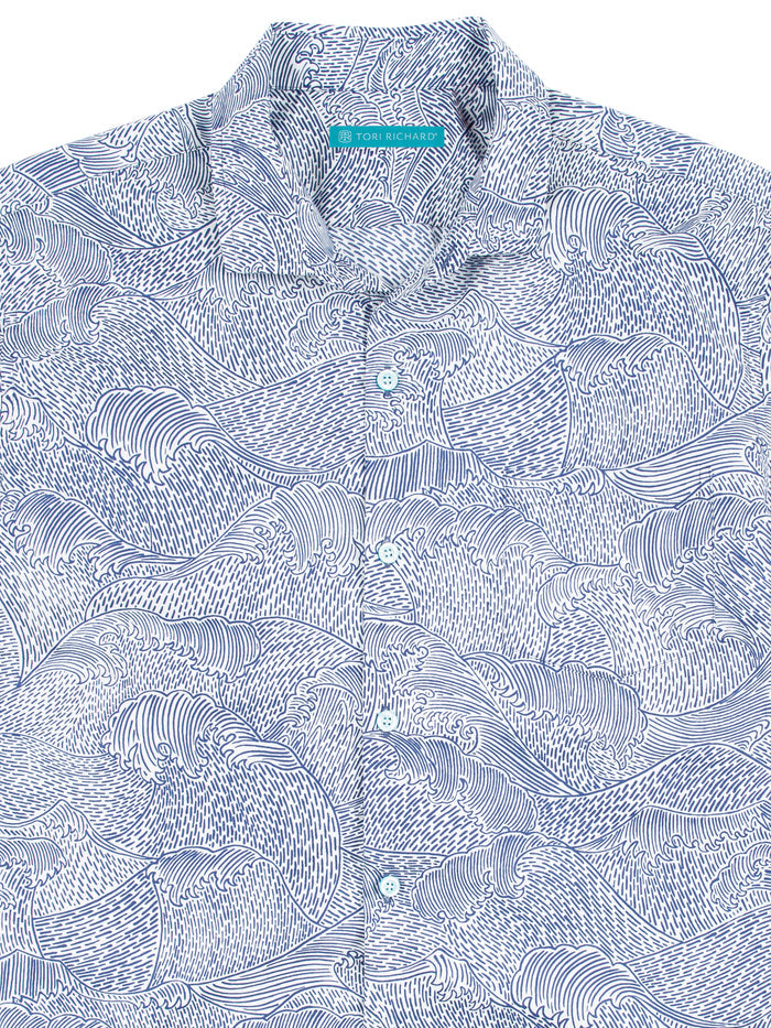 Blue and white wave-print cotton shirts, collared with front buttons, shown from the front.