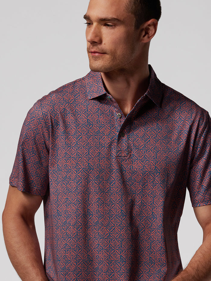 Blue geometric-print polo shirt, front view, with moisture-wicking, wrinkle-resistant, comfortable performance fabric.