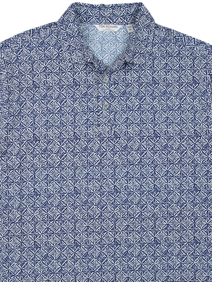 Blue and white geometric-pattern polo shirt with collar, front view on white background.