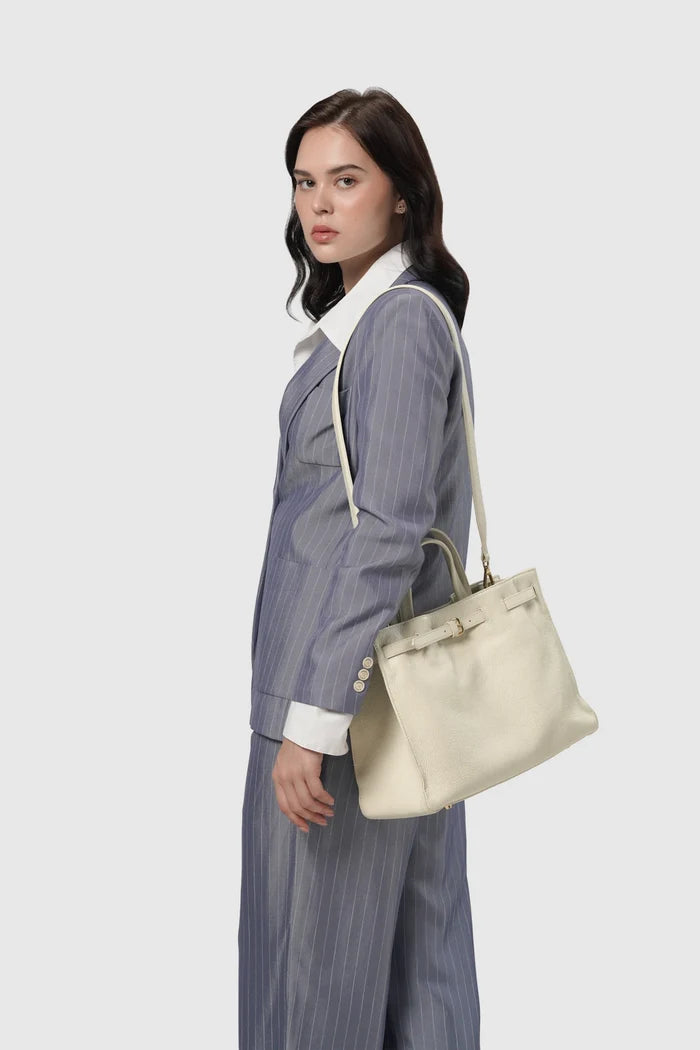 the city bag medium in gardenia by buttonscarves carried on shoulder