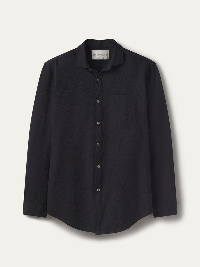 Black solid long-sleeve shirt with chest pocket, flat lay on white background.