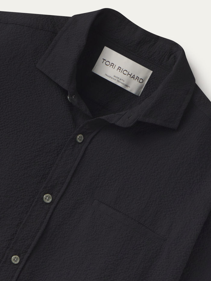 Black solid long-sleeve shirt with chest pocket; close-up shows collar with Tradewind Technology and Tori Richard label.